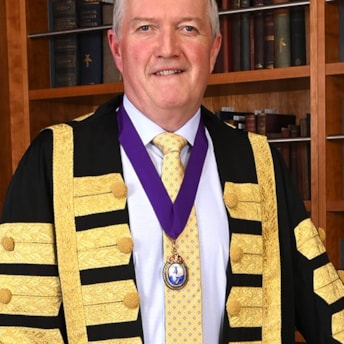 Headshot of Dr Diarmuid O'Shea in his presidential gown. Dr O'Shea is President of RCPI